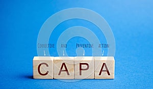 Wooden blocks with the word CAPA. Corrective and Preventive action plans. Business management concept. Strategy and efficiency. photo