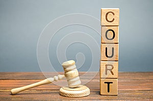 Wooden blocks with the word court and hammer of a judge. Settlement of disputes and consideration of criminal cases. Trial. Gavel photo