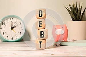 Wooden blocks with the word Debt. Reduction or restructuring of debt.