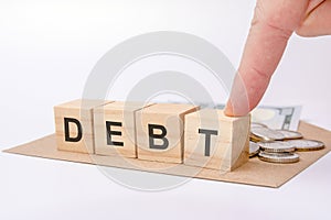 Wooden blocks with word Debt. reduction or restructuring of debt. refusal to pay debts or loans and invalidate them