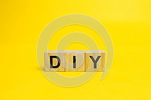 Wooden blocks with the word DIY - Do It Yourself concept. The method of self-creation of things without the help of professionals