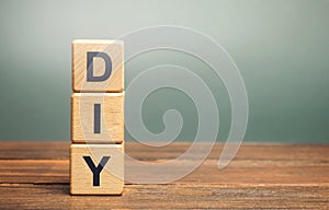 Wooden blocks with the word DIY - Do It Yourself concept. The method of self-creation of things without the help of professionals