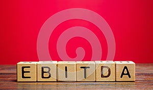 Wooden blocks with the word Ebitda. Earnings before interest, taxes, depreciation and amortization. Financial result of the