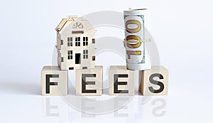 Wooden blocks with the word For FEES Real estate concept