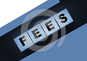 Wooden blocks with the word Fees . Taxes and fees business concept