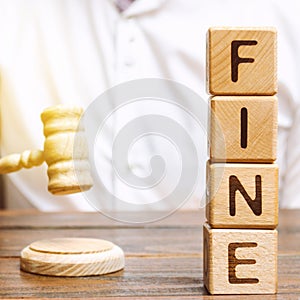 Wooden blocks with the word Fine and judge. Penalty as a punishment for a crime and offense. Financial punishment. Violations of