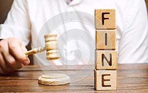 Wooden blocks with the word Fine and judge. Penalty as a punishment for a crime and offense. Financial punishment. Violations of photo