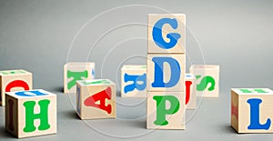 Wooden blocks with the word GDP  Gross domestic product . Financial measure of the market value of all the final goods and