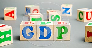 Wooden blocks with the word GDP  Gross domestic product . Financial measure of the market value of all the final goods and