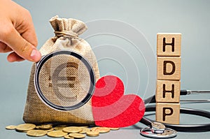 Wooden blocks with the word HDHP and money bag with euro sign. High-deductible health plan concept. Health insurance plan with photo