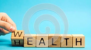 Wooden blocks with the word Health and Wealth. Concept of choosing priority in life and lifestyle. Make the right choice. Life
