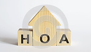 Wooden blocks with the word HOA , house. The concept of the high cost of rent for an apartment or home