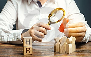 Wooden blocks with the word HR and businessman with a crowd of workers. Hiring, hire concept. Creation of a business team.