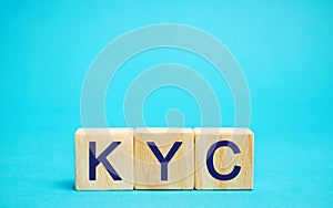 Wooden blocks with the word KYC - Know Your Customer / Client. Verify the identity, suitability and risks involved with