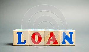 Wooden blocks with the word Loan. Consumer, banking and property loan. Business and entrepreneurial development. Small business