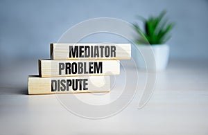 Wooden blocks with the word Mediator, dispute, problem, conflict. Settlement of disputes by mediator. Dispute Resolution