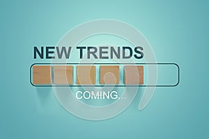 Wooden blocks with the word NEW TRENDS coming in loading bar progress. The concept of new ideological trends of fashion. New photo
