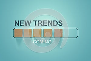 Wooden blocks with the word NEW TRENDS coming in loading bar progress. The concept of new ideological trends of fashion. New