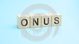 wooden blocks with the word ONUS, blue background