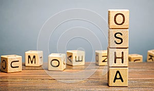 Wooden blocks with the word OSHA - Occupational Safety and Health Administration