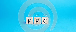 Wooden blocks with the word PPC. Internet advertising model used to drive traffic to websites. Internet marketing concept, social