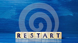 Wooden blocks with the word Restart. New beginning and launch. Start of a new process. Back to the roots. Business concept. Start
