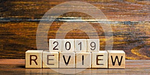 Wooden blocks with the word Review 2019. Business concept. Feedback, Progress. New trends and prospects. Financial performance