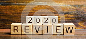 Wooden blocks with the word Review 2020. Business concept. Feedback, Progress. New trends and prospects. Financial performance