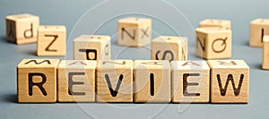 Wooden blocks with the word Review. Customer review concept. Reviewing, auditing, reviewer. Service rating. Feedback photo