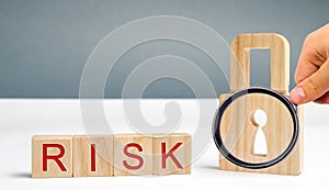 Wooden blocks with the word Risk and lock. Imperfect security system. High risk of hacking and theft of personal data. Insecure