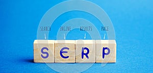 Wooden blocks with the word SERP - Search Engine Results Page. Pages displayed by search engines in response to a query by a user