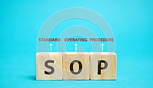 Wooden blocks with the word SOP  Standard operating procedure . Instructions to assist employees in complex routine operations.