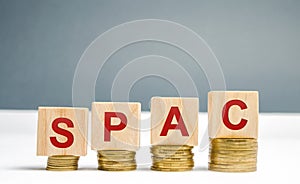 Wooden blocks with the word SPAC - Special purpose acquisition company. Simplified listing of company, merger bypassing stock