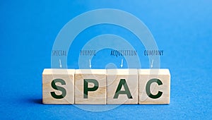 Wooden blocks with the word SPAC - Special purpose acquisition company. Simplified listing of company, merger bypassing stock