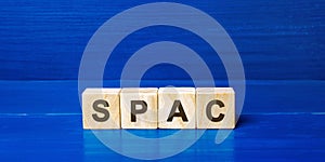 Wooden blocks with the word SPAC - Special purpose acquisition company. Simplified listing of company, merger bypassing stock