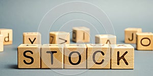 Wooden blocks with the word Stock. Trading on the stock exchange. Investment portfolio. Capital gains. Common and preferred stocks photo