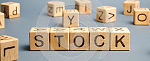 Wooden blocks with the word Stock. Trading on the stock exchange. Investment portfolio. Capital gains. Common and preferred stocks