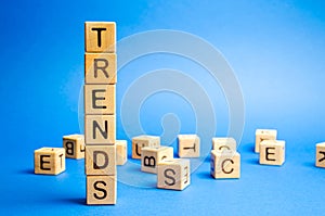 Wooden blocks with the word Trends. Popular and relevant topics. New ideological trends of fashion. Recent and latest trend.