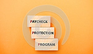 Wooden blocks with words Paycheck Protection Program. Loan that helps businesses keep their workforce employed during the COVID-19