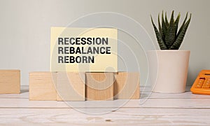 Wooden blocks with words 'Recession Rebalance Reborn