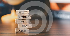Wooden blocks with words \'Study Abroad? We Can Help! Concept of global business study, abroad educational, Back to School.