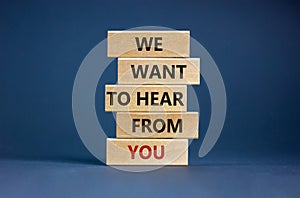 Wooden blocks with words `we want to hear from you`. Beautiful grey background. Copy space. Business concept