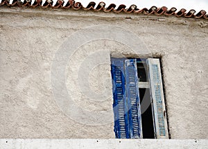 Wooden blue front door and windows on a dilapidated house