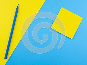 Wooden blue pencil isolated on yellow texture paper