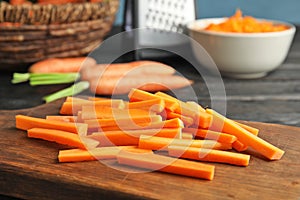 Wooden board with carrot sticks