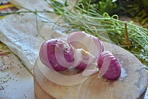 Wooden board with chopped red onion .