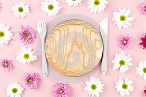 Wooden board and cutlery in flowers