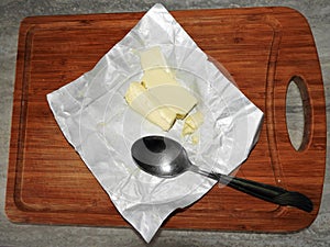 Wooden board for cutting foods on the table in the kitchen.