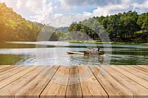 Wooden board empty table blur lake in forest background.