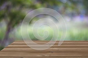 Wooden board empty table blur trees background